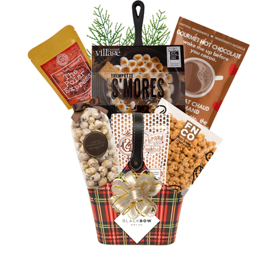 The Merry Mix Christmas gift basket in a red tartan leatherette keepsake basket featuring gourmet holiday treats, hot chocolate, popcorn and festive greenery.
