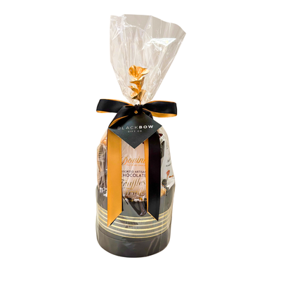 Gourmet chocolate gift basket featuring artisan chocolate truffles, handcrafted chocolate pecan clusters, cookies and cream popcorn, gourmet roasted nuts, and premium sweet treats, beautifully wrapped for gifting.