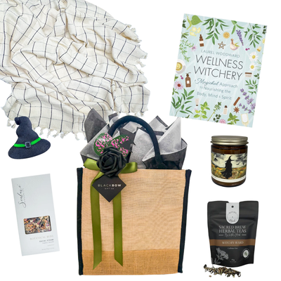 A Little Magic wellness gift basket with cozy throw, herbal tea, candle, wellness book and self-care treats