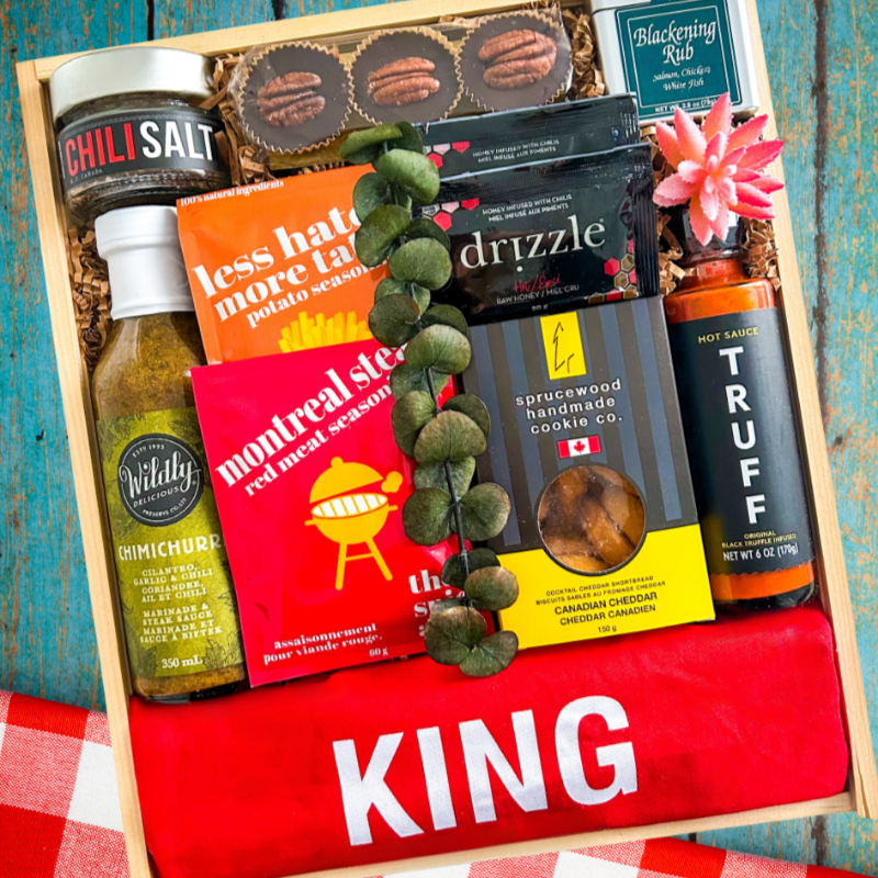 BBQ Gift for Father's Day with Kind of the Grill Apron and other BBQ accessories and premium food items.