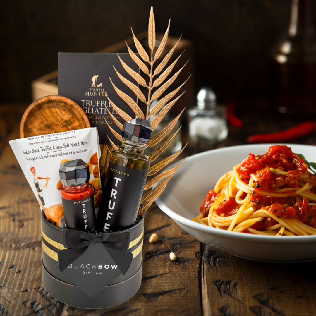 TruffleHunter truffle oil bottle with a bowl of spaghetti on a wooden table