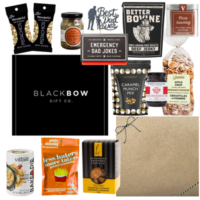 Dad’s Snack Stash Father’s Day gourmet gift box with jerky, pistachios, caramel snacks, smoky seasonings, cookies, dip mix, and dad-themed treats in a sleek black gift box.