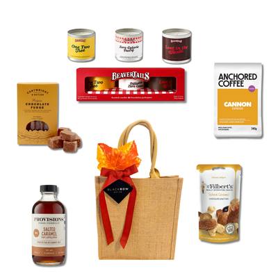 A Good Moment coffee gift with espresso, salted caramel coffee syrup, chocolate fudge, gourmet treats and a playful candle trio presented in a reusable burlap tote by Black Bow Gift Co.