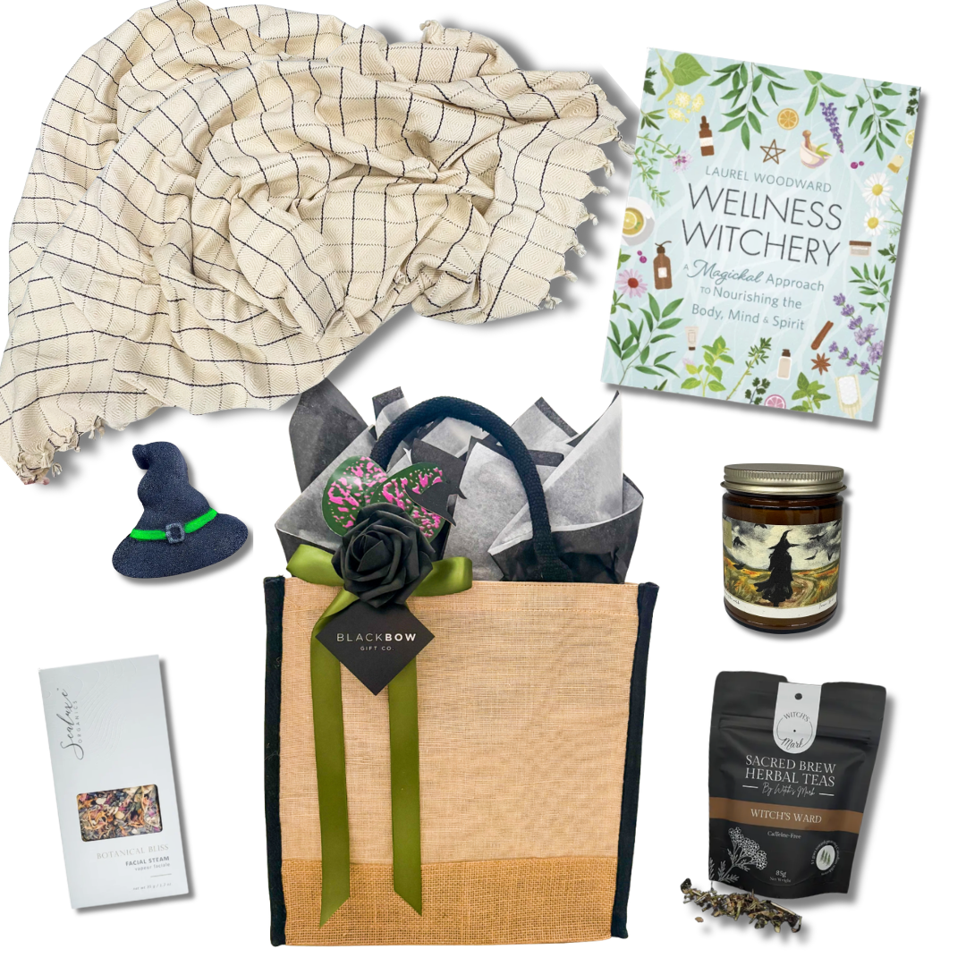 A Little Magic wellness gift basket with cozy throw, herbal tea, candle, wellness book and self-care treats

