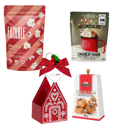 A Cozy Christmas holiday gift featuring a red gingerbread house keepsake filled with festive popcorn, hot chocolate mix, gingerbread fudge and seasonal greenery.