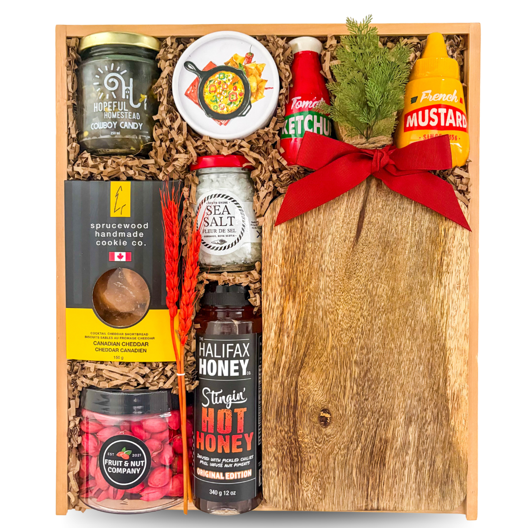 Rustic gourmet BBQ gift box featuring wooden serving board, hot honey, cowboy candy, gourmet snacks, chocolates, and entertaining-inspired presentation by Black Bow Gift Co.

