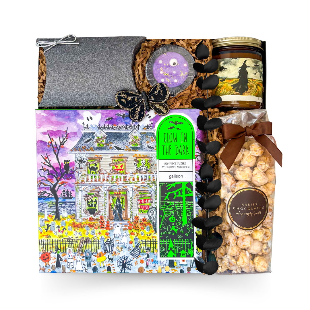 Boo Box Halloween gift with glow-in-the-dark puzzle, candle, popcorn, pumpkin pouch filled with chocolates and black sparkle candy pouch.

