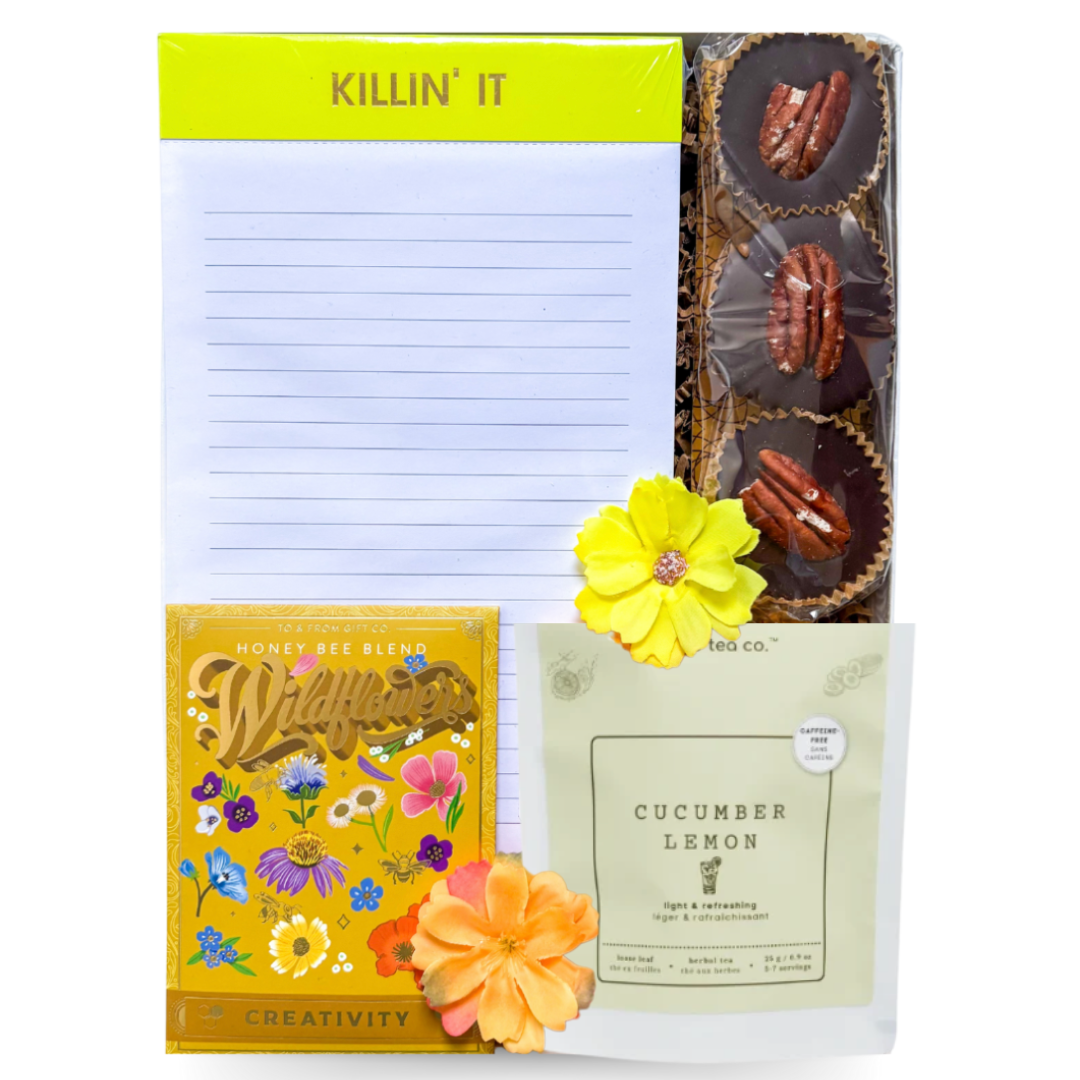Killin' It gift box with notepad, nutty caramel cups, creativity wildflower seed packet, cucumber lemon tea, presented in a white gift box with gold ribbon.