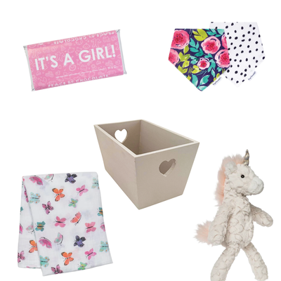 Butterfly Wishes baby girl gift basket with plush unicorn, butterfly muslin swaddle, floral baby bibs, It's a Girl chocolate, and premium gift packaging.