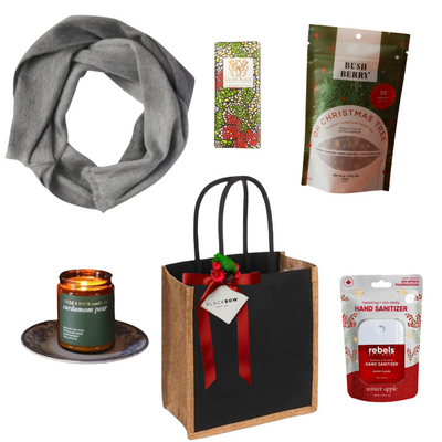 Comfort & Joy holiday gift tote featuring a soft grey blanket, festive teas, artisan chocolate, seasonal candle, winter apple hand sanitizer and reusable black tote.