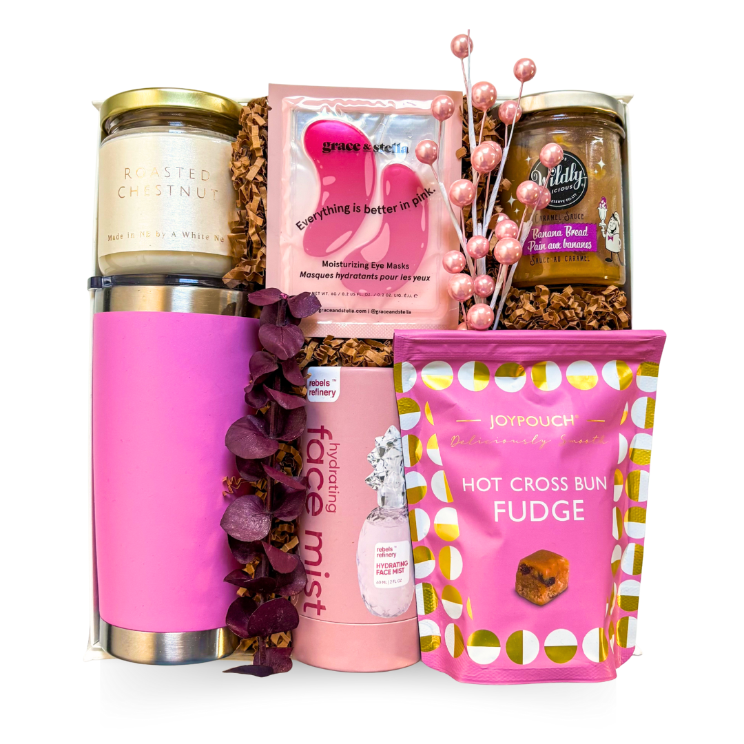 Cozy in Pink gift with bright pink tumbler, pink-themed treats, candle, and feminine winter self-care accents

