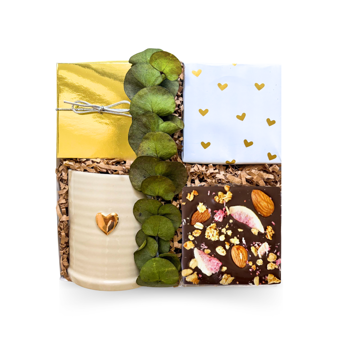 Luxury coffee and tea gift box featuring a keepsake heart mug, handcrafted chocolate, gourmet treats, and a choice of premium tea, hot chocolate, or vanilla latte, beautifully presented in a luxury small gift box.

