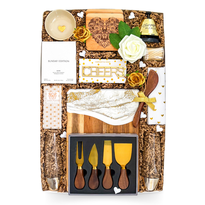 Luxury entertaining gift box featuring gourmet treats, serving accessories, candle, charcuterie essentials, stemless glasses, and elegant presentation by Black Bow Gift Co.
