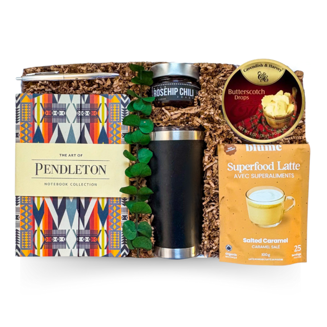 Everyday Essentials Box with tumbler, notebook, savoury bacon jam, crackers, and cozy drink elements
