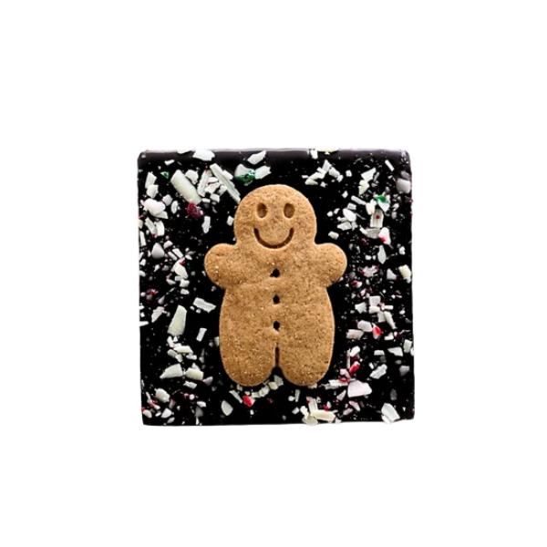 60% Belgian dark chocolate bar topped with white chocolate flakes and crushed candy cane, featuring a gingerbread man design, perfect for Christmas gift boxes and holiday treats.