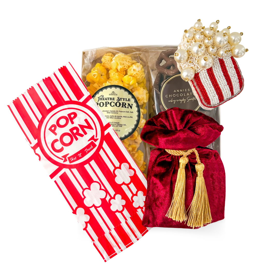 Feature Presentation movie night gift with theatre-style popcorn, chocolate pretzels, velvet treat pouch and optional movie-inspired ornament.

