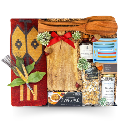 Luxury cabin-inspired gift basket in a large high-gloss black magnetic keepsake gift box featuring premium gourmet foods, artisan charcuterie boards, cozy throw, maple syrup, coffee, baked brie essentials, and entertaining accessories.