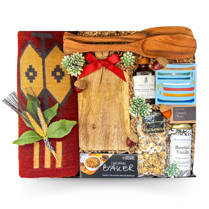 Luxury cabin-inspired gift basket in a large high-gloss black magnetic keepsake gift box featuring premium gourmet foods, artisan charcuterie boards, cozy throw, maple syrup, coffee, baked brie essentials, and entertaining accessories.

