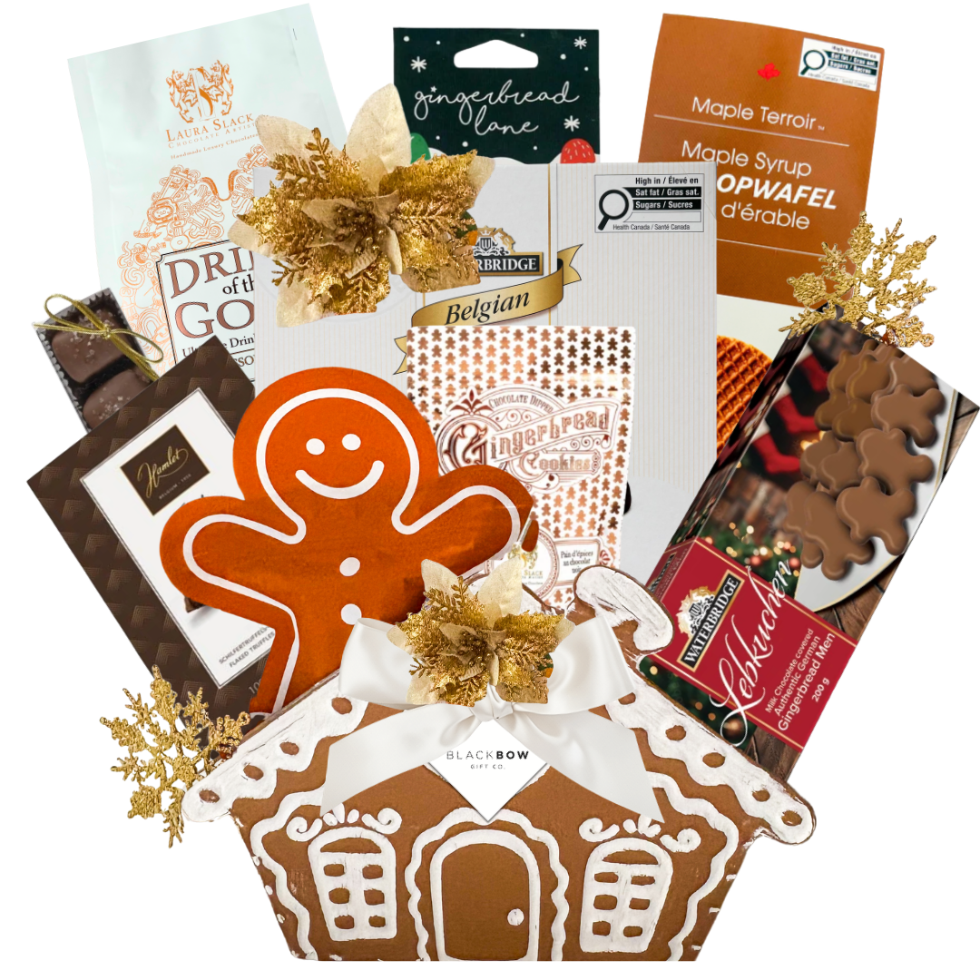 Gingerbread Wishes Christmas gift basket featuring festive chocolates, gingerbread treats, a decorative gingerbread house keepsake ornament and elegant gold holiday accents.