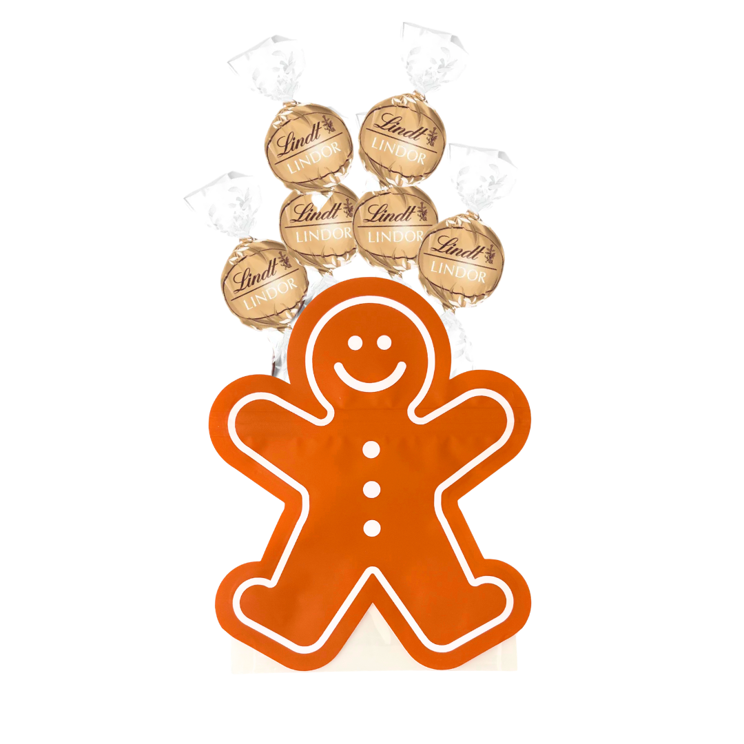 Gingerbread Man-shaped chocolate box filled with gold Lindt Lindor chocolates.