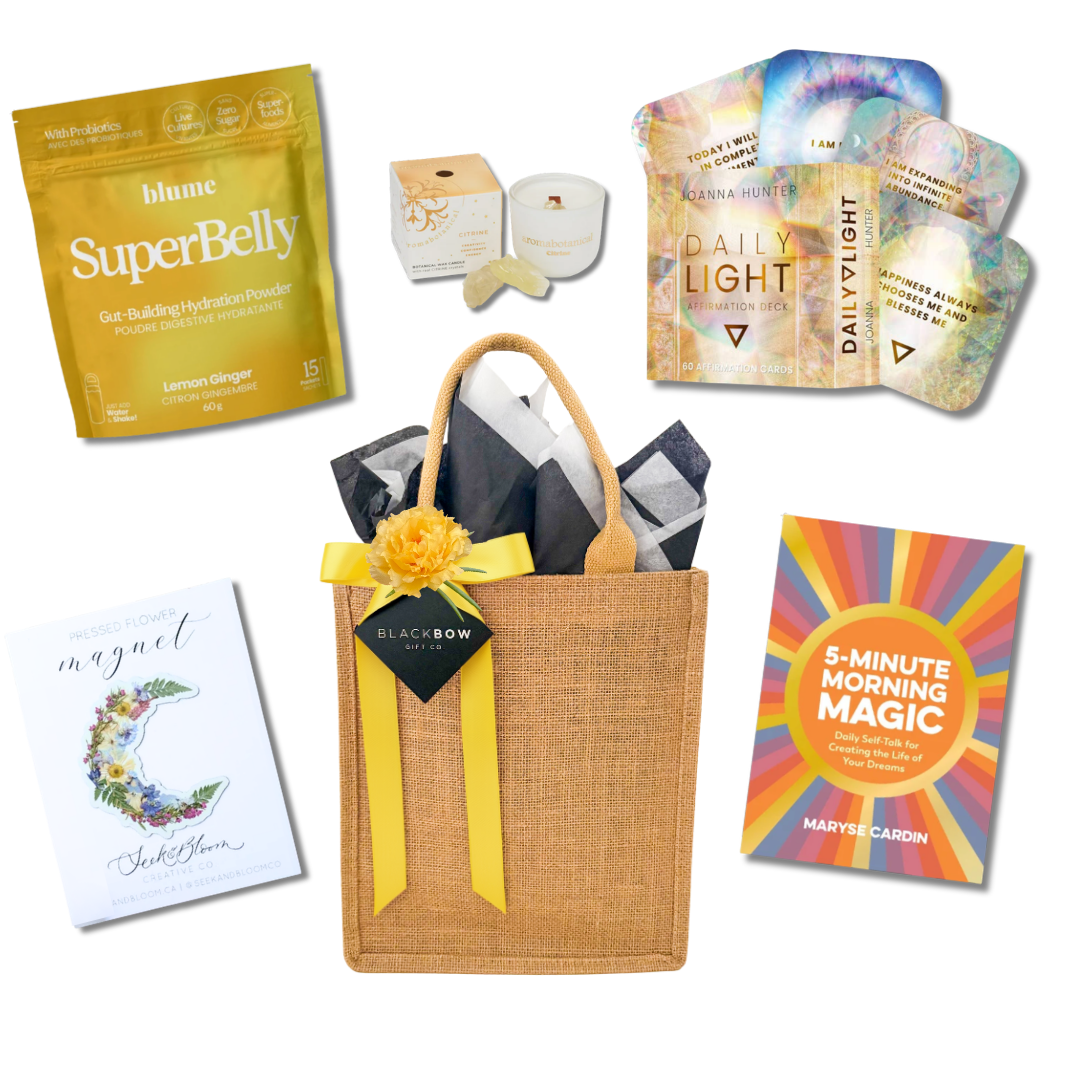 Good Energy wellness gift with hydration mix, affirmation cards, positive mindset book, candle and pressed flower magnet in a reusable tote.