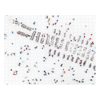Gray Malin The Snow Side jigsaw puzzle featuring an aerial view of skiers and snowboarders on a snowy white mountainside, with colourful figures scattered across the winter landscape.