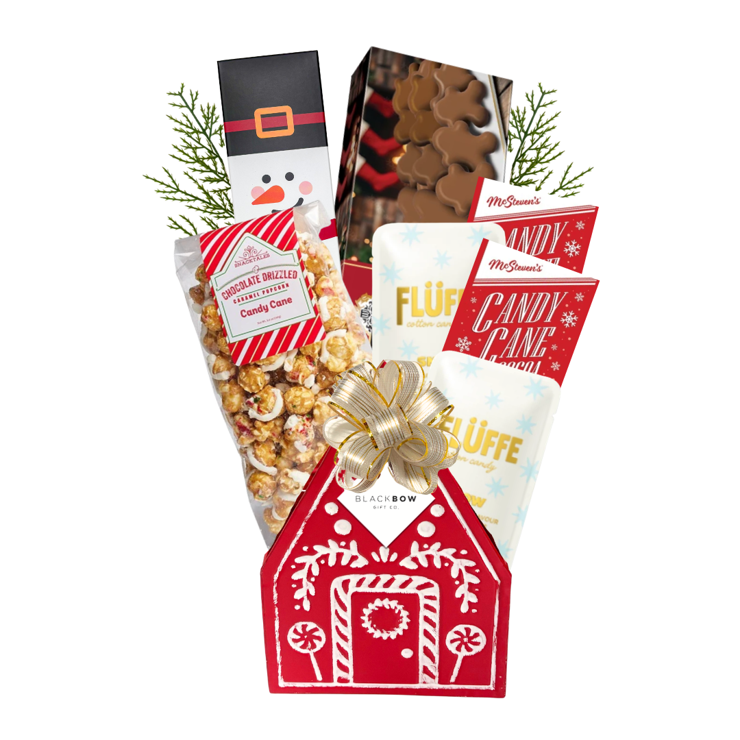Holiday Happiness Christmas gift basket featuring a red gingerbread house keepsake filled with festive chocolates, cookies, candy cane popcorn and holiday treats.