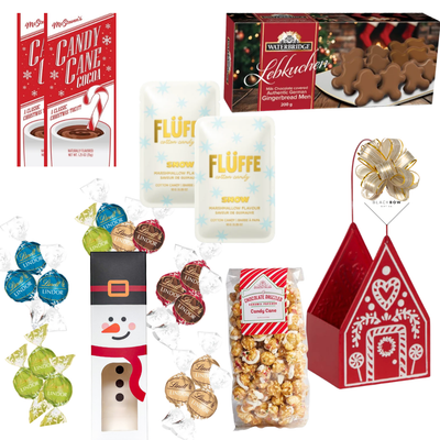 Holiday Happiness Christmas gift basket featuring a red gingerbread house keepsake filled with festive chocolates, cookies, candy cane popcorn and holiday treats.