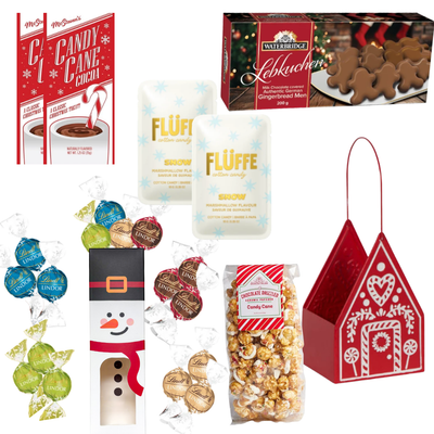 Holiday Happiness Christmas gift basket featuring a red gingerbread house keepsake filled with festive chocolates, cookies, candy cane popcorn and holiday treats.