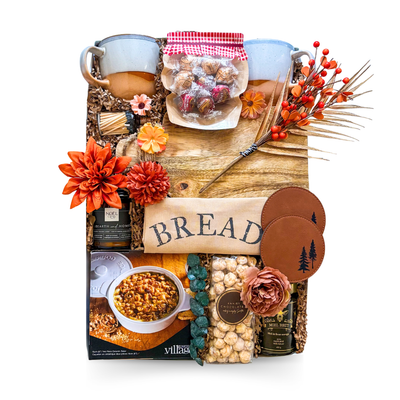 Home Comforts gift box with matching ceramic mugs, wood serving board, kitchen linens, candle, coffee, tea, cinnamon rolls, pancake mix, maple syrup and gourmet treats by Black Bow Gift Co.