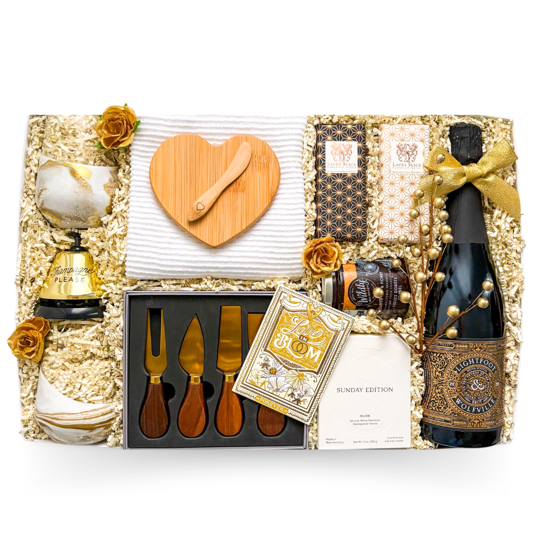 Celebration gift box with wine, brie baker, serving pieces, and gourmet treats by Black Bow Gift Co.
