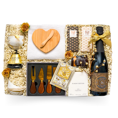 Celebration gift box with wine, brie baker, serving pieces, and gourmet treats by Black Bow Gift Co.