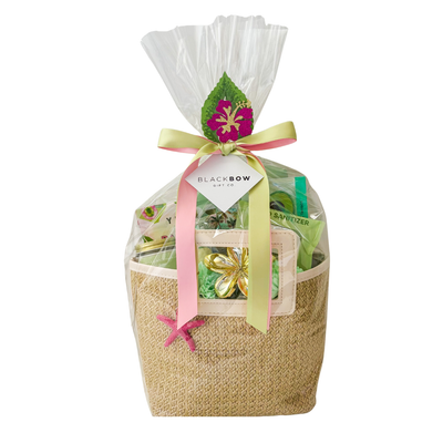 Island Time tropical gift featuring a reusable straw purse filled with vacation-inspired self-care treats, sweet snacks, and cheerful relaxation essentials. Beautifully arranged with bright tropical accents, ribbon, and seasonal details, creating a fun and thoughtful gift perfect for birthdays, thank-you gifts, self-care, and summer celebrations.