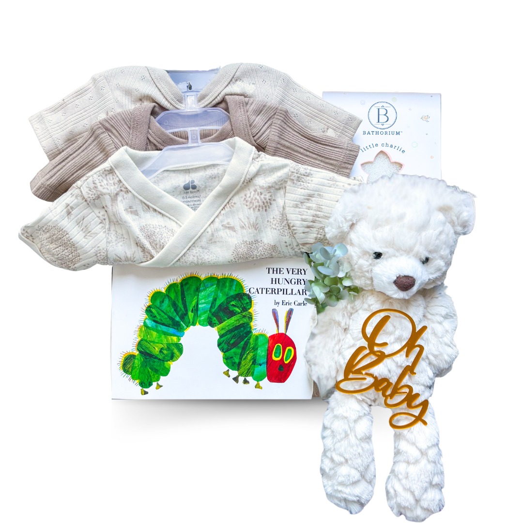 Little Wonder gender neutral baby gift box with neutral baby clothing, plush bear, bath mitt and The Very Hungry Caterpillar book.

