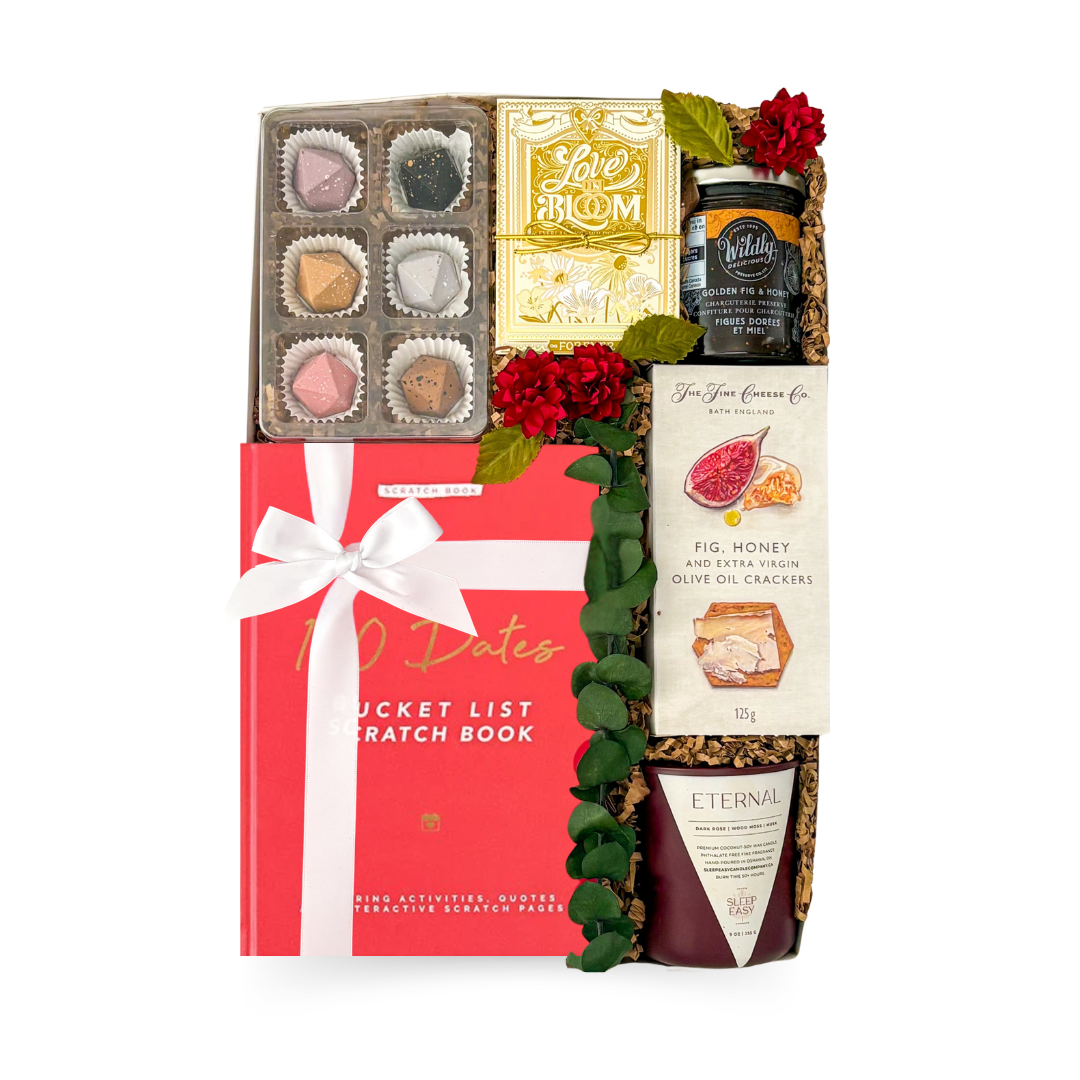 Wedding gift box featuring a date night scratch book, Love Blooms seed kit, hand-painted artisan caramels, gourmet crackers, fig preserve, candle, and thoughtful keepsakes by Black Bow Gift Co.