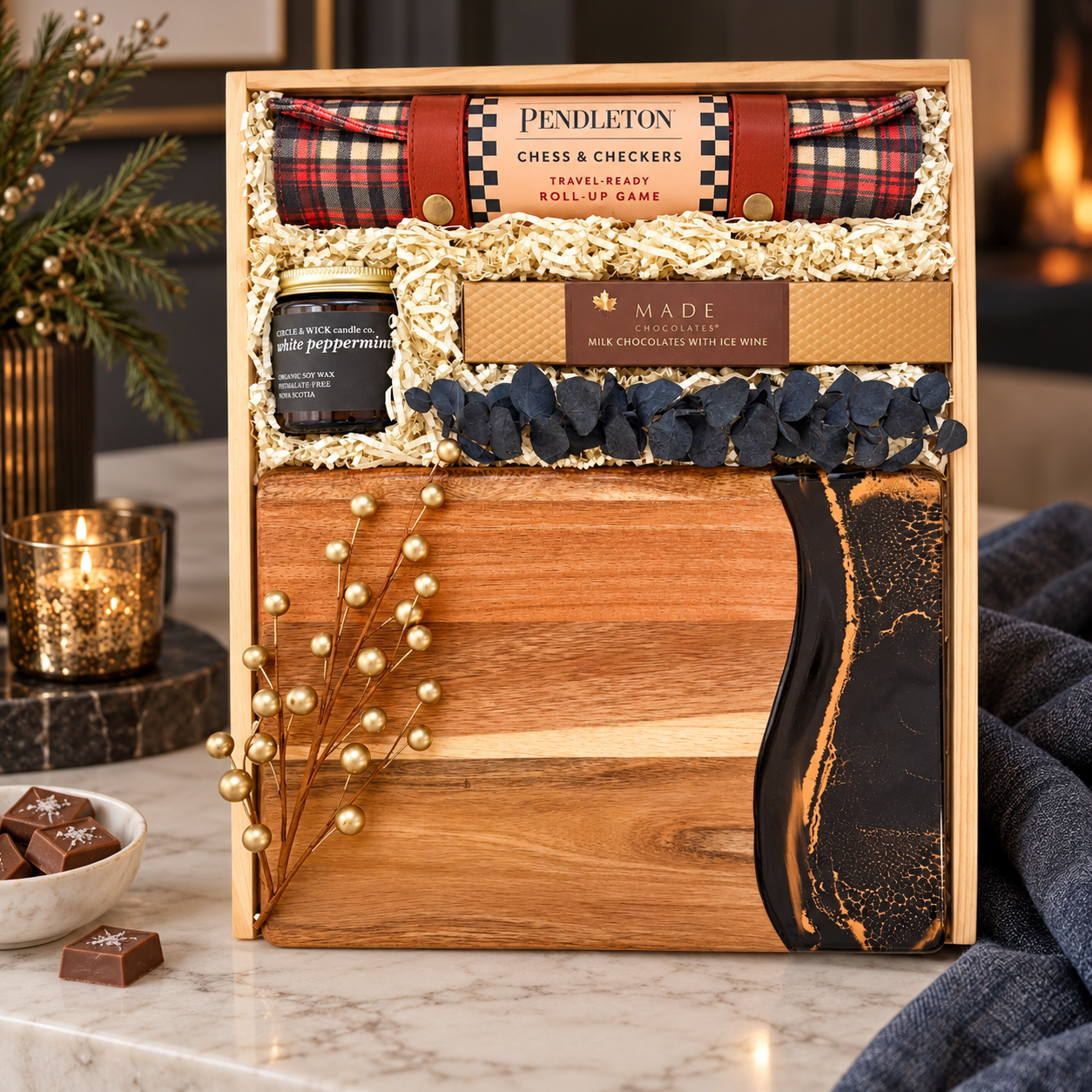 
Luxury wooden gift box featuring a Pendleton chess and checkers set, artisan chocolates, peppermint candle, and wood serving board with black and gold resin detailing, styled in a warm, elegant setting with soft candlelight and cozy accents.