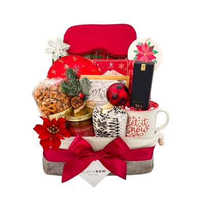 Luxury Brr Basket winter gift with blanket, candle, tea, socks, and seasonal treats creating a cozy holiday experience.