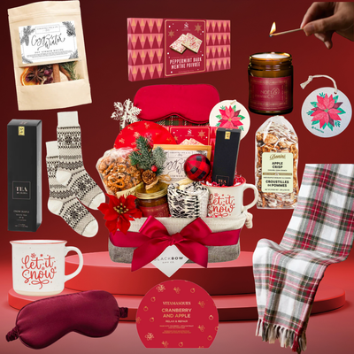 Luxury Brr Basket winter gift with blanket, candle, tea, socks, and seasonal treats creating a cozy holiday experience.