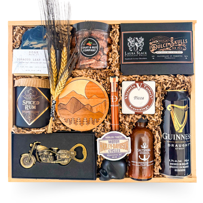 Luxury wood gift box for him featuring artisan soap, gourmet snacks, hot honey, hot sauce, whiskey toothpicks, chocolates, candle, and rugged masculine presentation by Black Bow Gift Co.