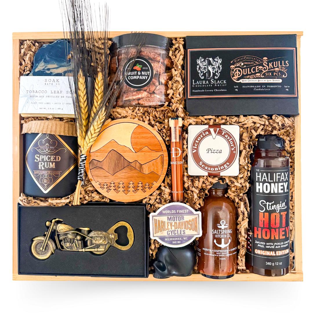 Luxury wood gift box for him featuring artisan soap, gourmet snacks, hot honey, hot sauce, whiskey toothpicks, chocolates, candle, and rugged masculine presentation by Black Bow Gift Co.