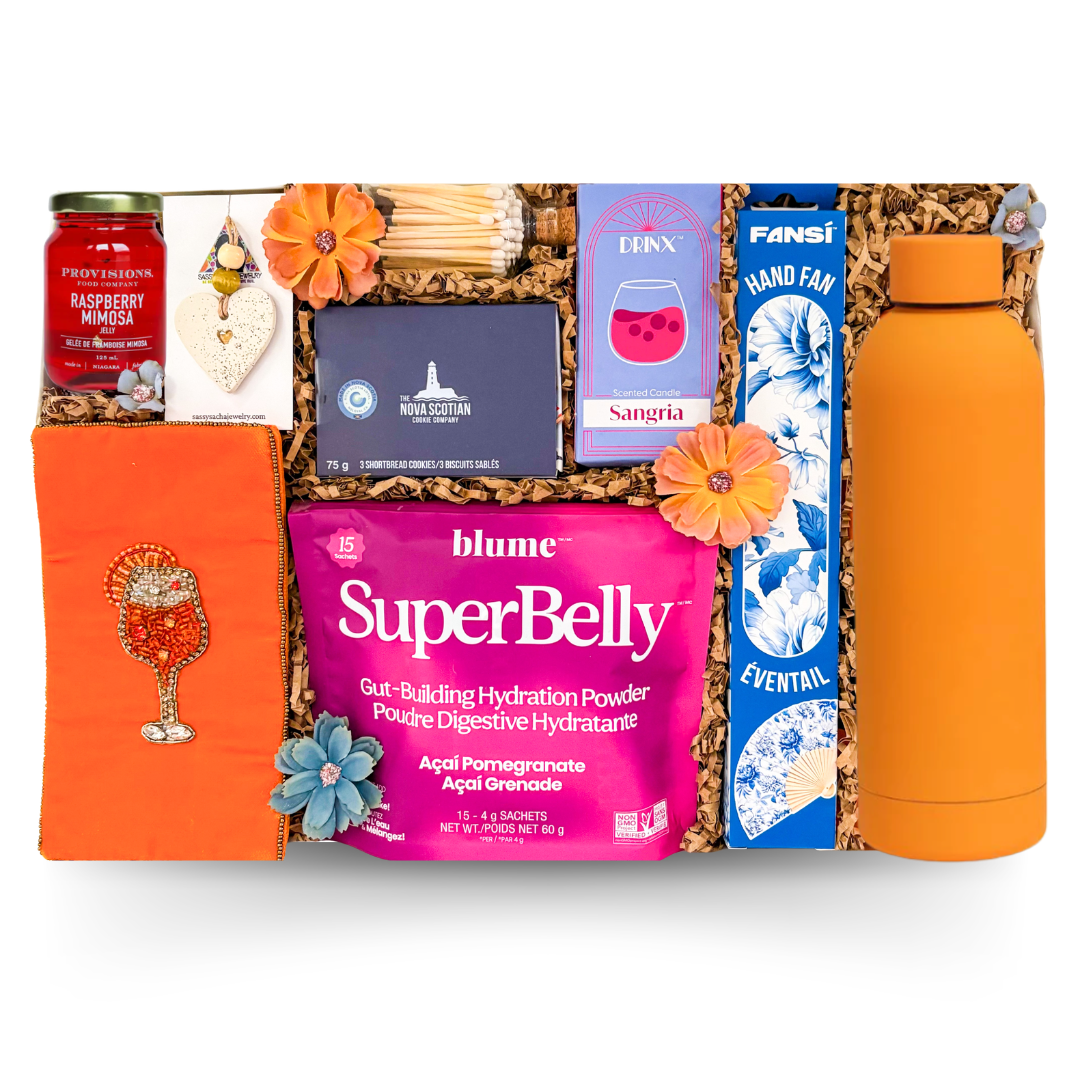 Bright summer-inspired gift box featuring orange tumbler, sangria candle, hand fan, gourmet treats, wellness drink mix, and elevated colorful presentation by Black Bow Gift Co.