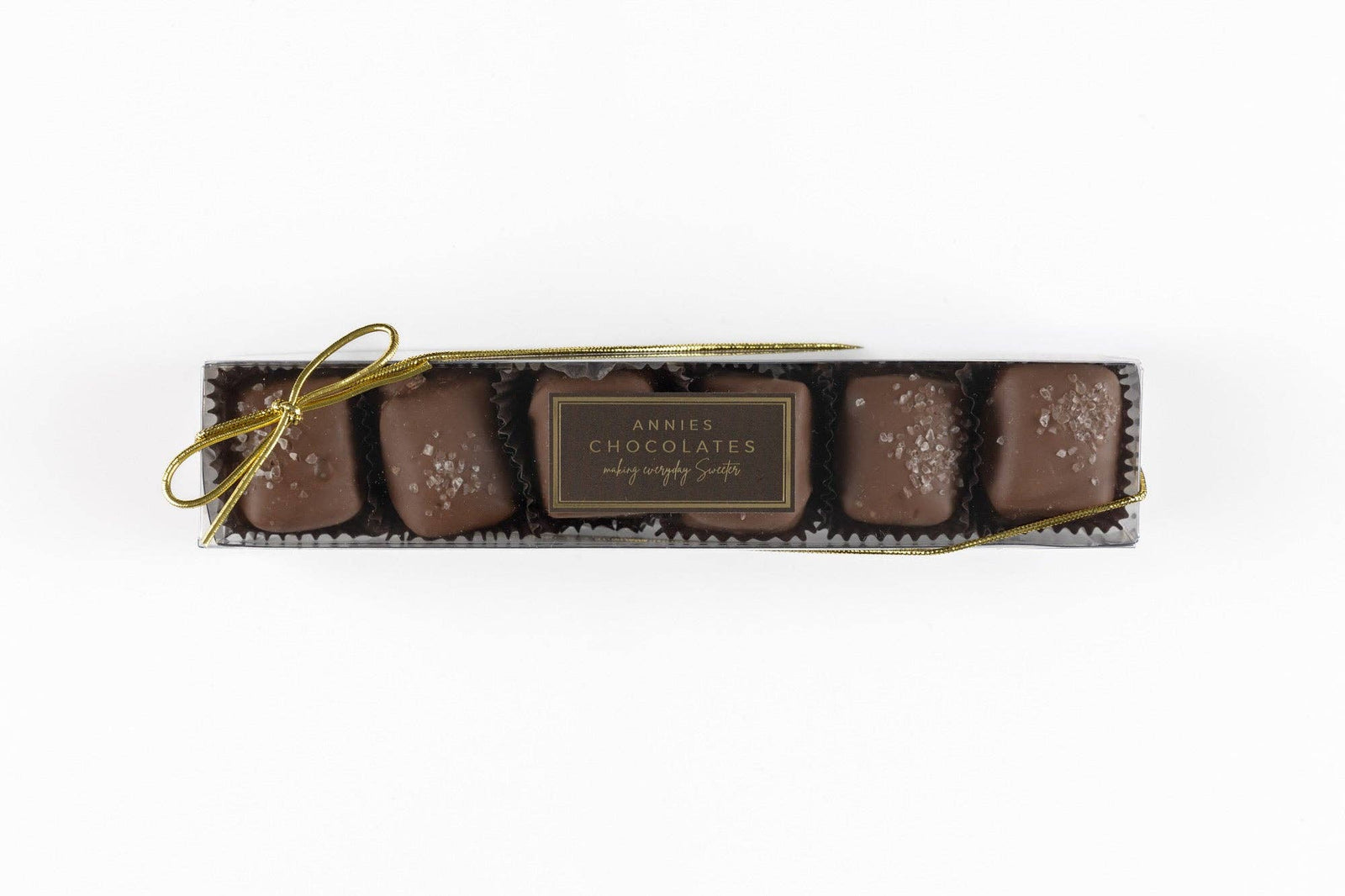 Annie’s Chocolates milk chocolate covered caramel with sea salt in clear rectangular box