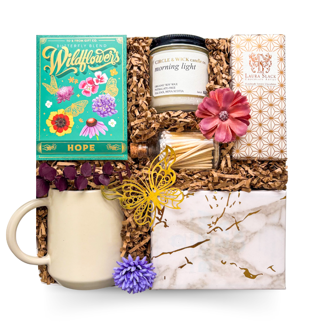A soft, hopeful care package with tea, a heart mug, candle, seed packs, and more. Thoughtful gifting for comfort, healing, and support.