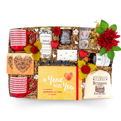 XL gift box featuring matching mugs, keepsake journal for two, gourmet breakfast treats, artisan caramels, preserves, tea, and thoughtful couple-inspired gifts by Black Bow Gift Co.