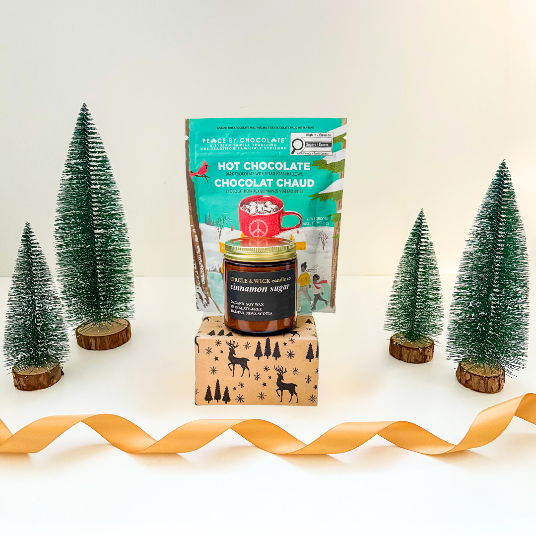 Festive holiday gift basket with hot chocolate, cookies, and candle by Black Bow Gift Co.
