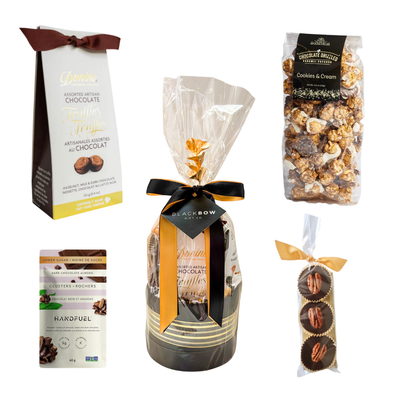 Gourmet chocolate gift basket featuring artisan chocolate truffles, handcrafted chocolate pecan clusters, cookies and cream popcorn, gourmet roasted nuts, and premium sweet treats, beautifully wrapped for gifting.