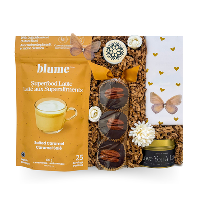 Women-founded self-care gift box with sugar-free chocolate, latte candle, salted caramel latte mix, caramel nutty cups, and lip balm in a budget-friendly signature box