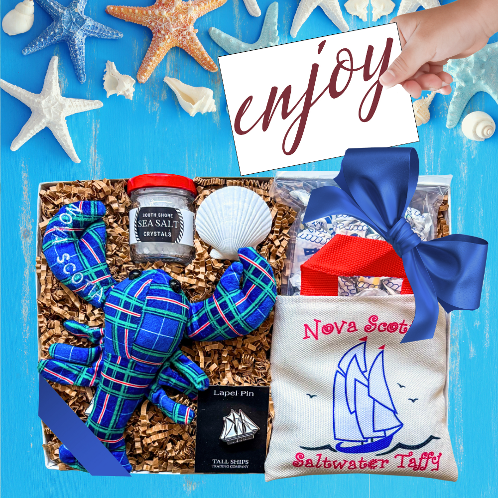 Nova Scotia Gift Box with Bluenose pin, tartan lobster, sea salt, and taffy in a sailboat bag styled as a coastal keepsake.