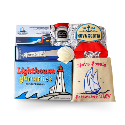 Nova Scotia themed gift box featuring local treats, sea salt, lighthouse gummies, a Nova Scotia spreader, shortbread cookies and a choice of keepsake patch or pressed flower magnet by Black Bow Gift Co.