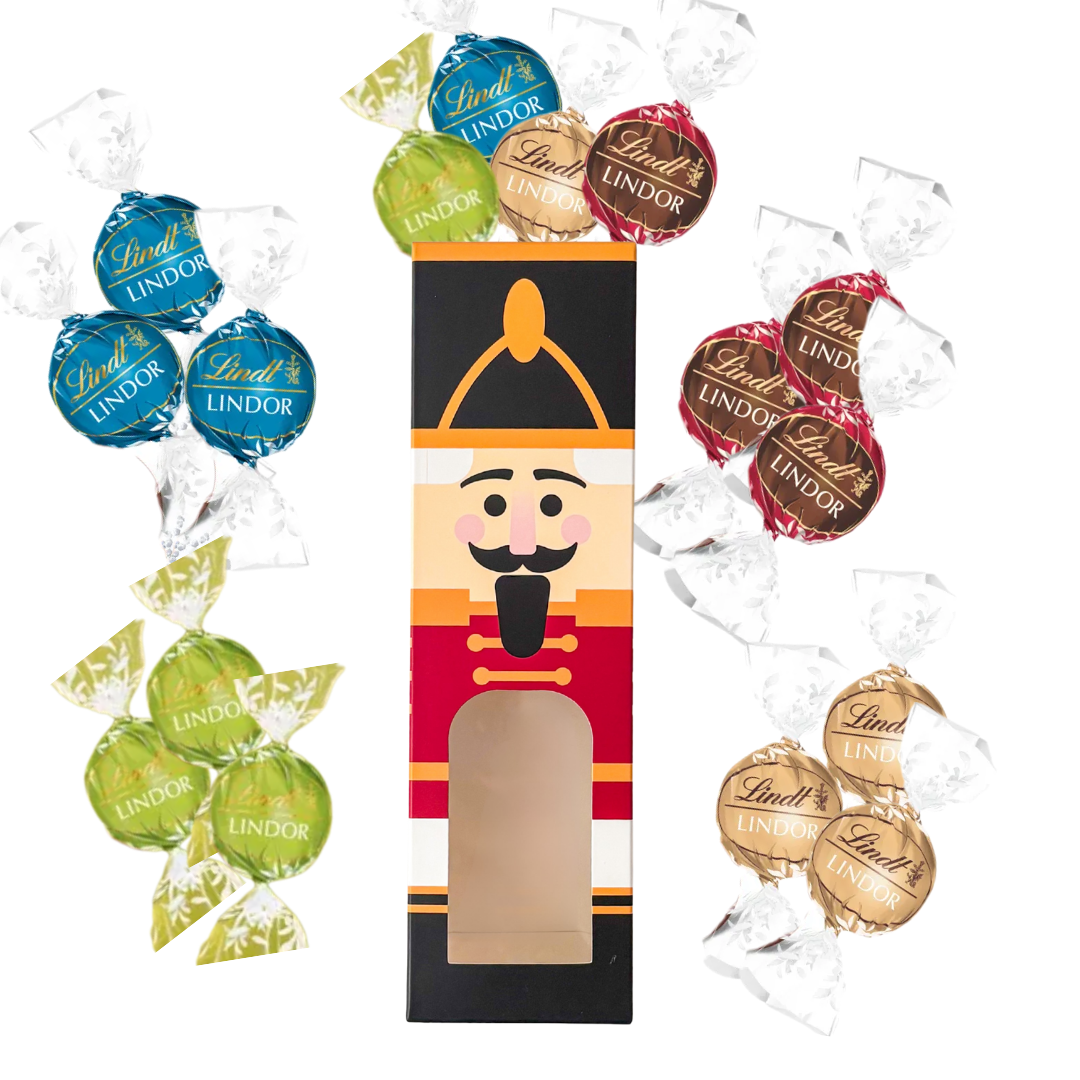 Christmas nutcracker chocolate box filled with Lindt Lindor chocolates in assorted red, blue, gold and green wrappers, surrounded by additional Lindt Lindor chocolates.